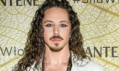 Michał Szpak bez bluzeczki z umięśnionym torsem. Stanął na ściance w rozpiętej marynarce