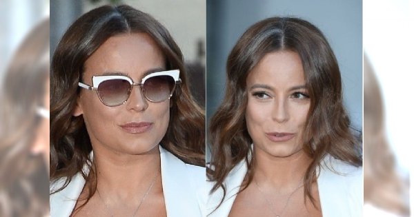 Anna Mucha w białym garniturze. Jej piersi prawie wyskoczyły z tej bluzki