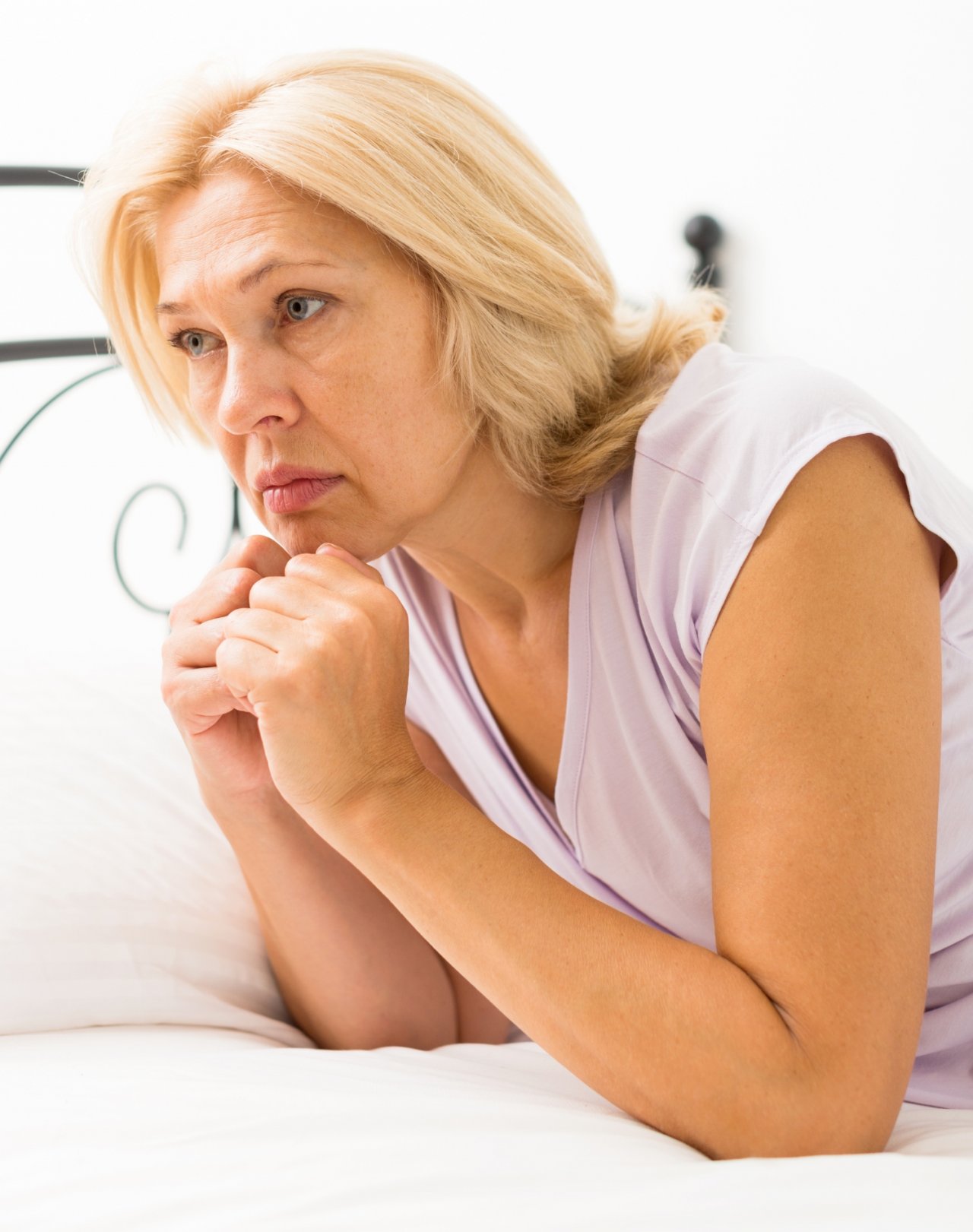 Smutna kobieta w średnik wieku w jasnym topie