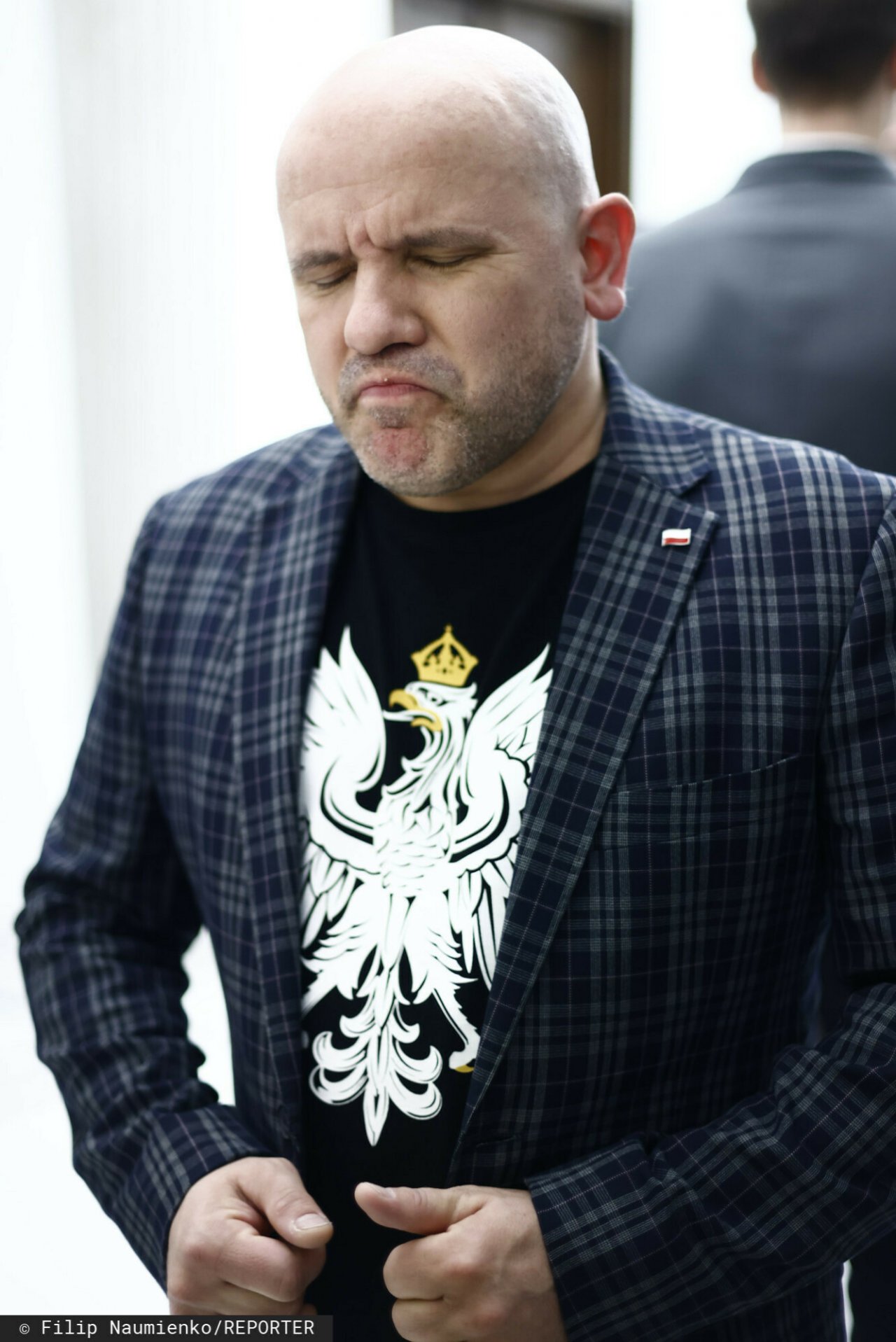 Mariusz Gosek w koszulce z orłem, skrzywiona mina