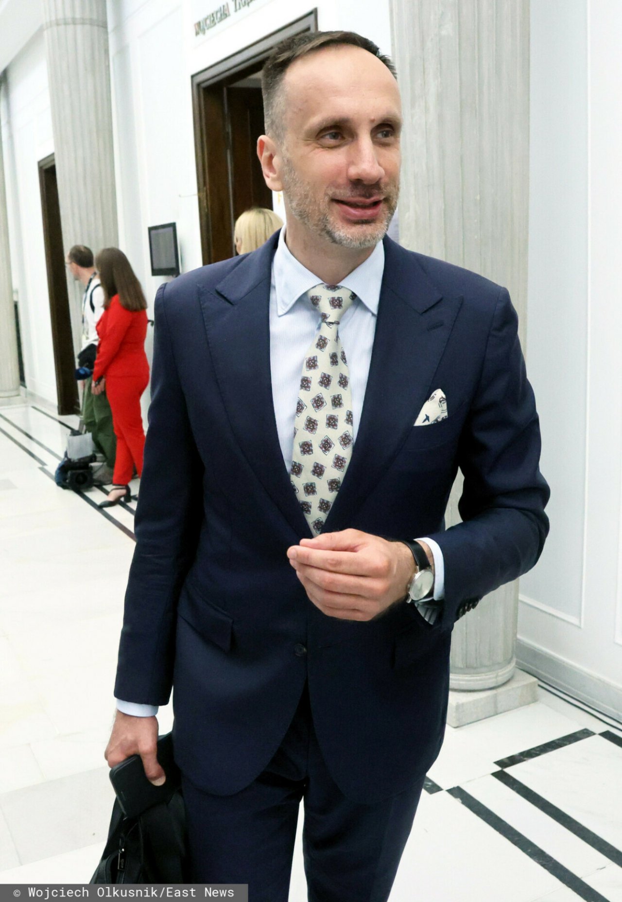 Janusz Kowalski w garniturze granatowym