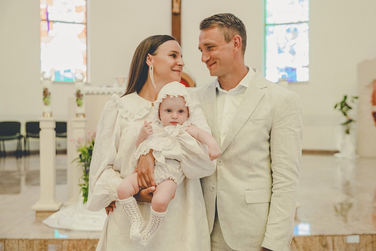 Jakub i Paulina Rzeźniczakowie z córką w kościele