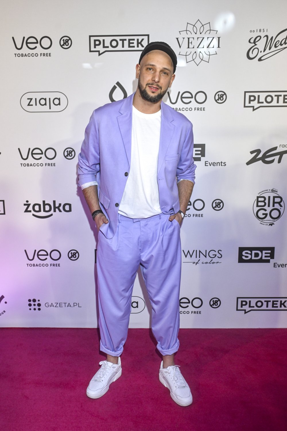 Maciej Pela w fiołkowym garniturze