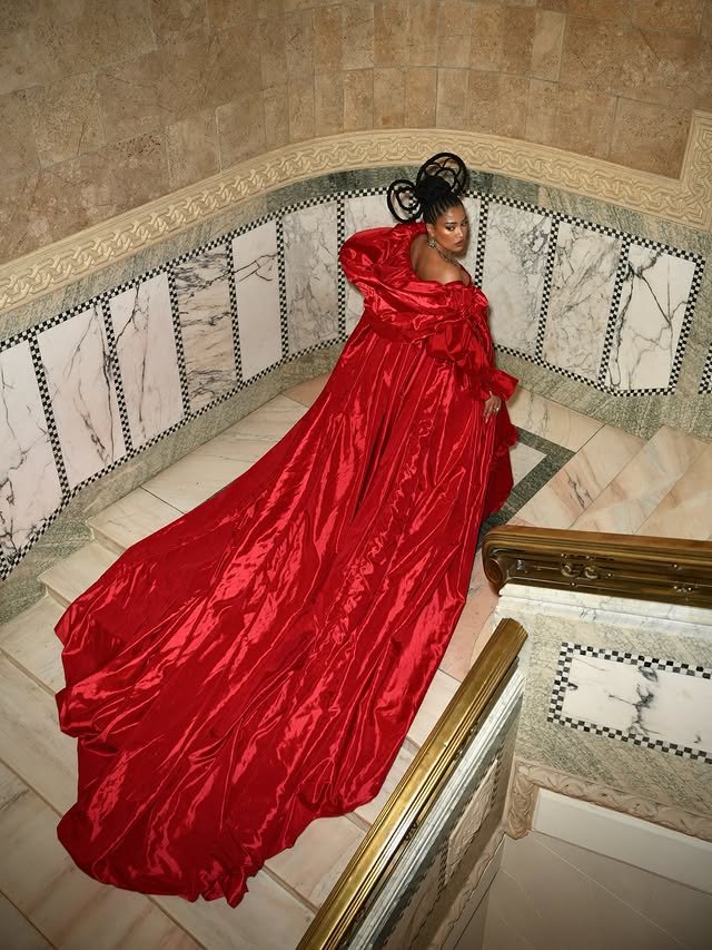 Patricia Kazadi w czerwonej stylizacji idzie po schodach