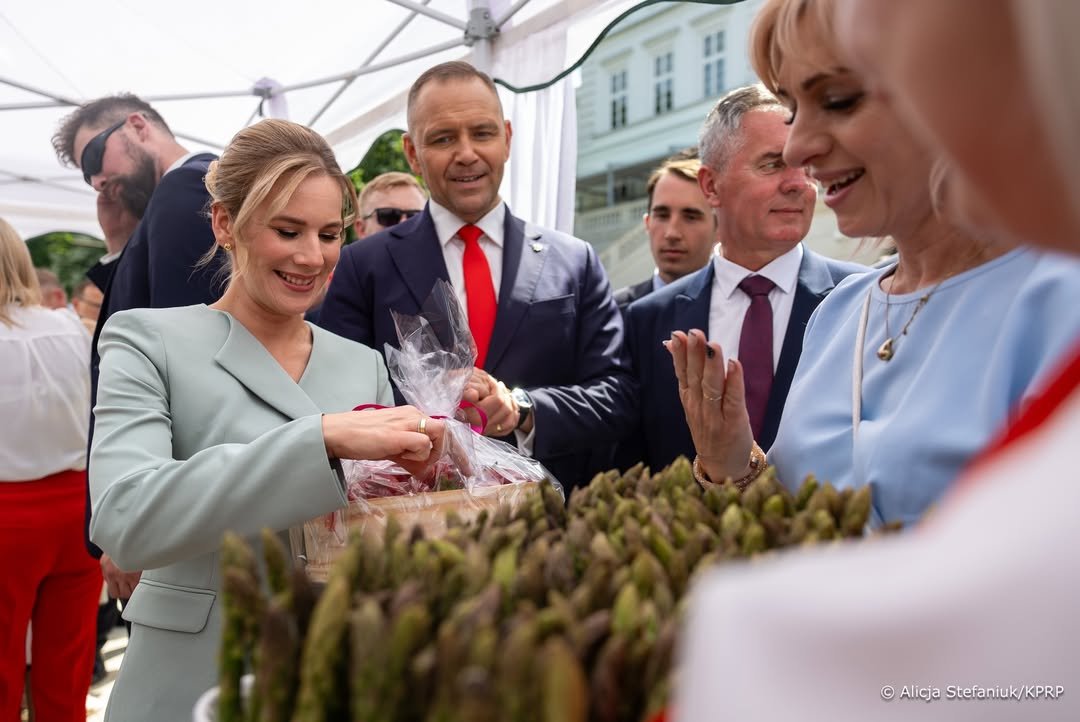 Marta Nawrocka z mężem i grupka osób wsród warzyw