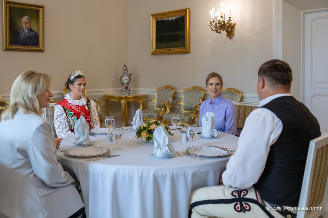 Marta Nawrocka z góralami w pałacu prezydenckim przy zastawionym stole