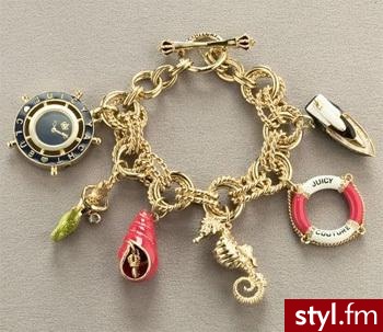 Juicy Couture - złoto, przewieszki przywołują na myśl morze bądź ocean. Coś dla kochających rejsy. 
Cena: 495$ - Pozostałe Dodatki Moda